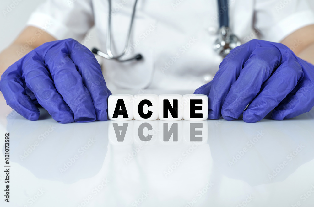 The doctor put together a word from cubes ACNE The doctor put together a word from cubes ACNE