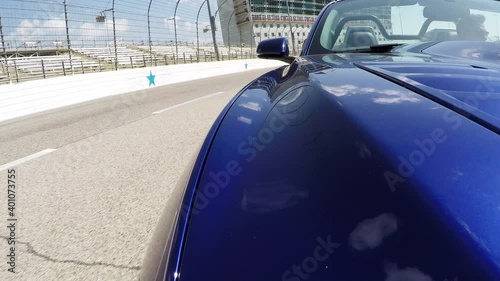 View from hood of car driving on racetrack photo