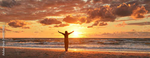 Happy woman on the sunset beach