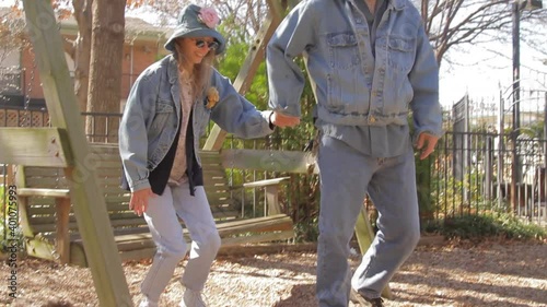 Couple standing and leaving swinging bench photo