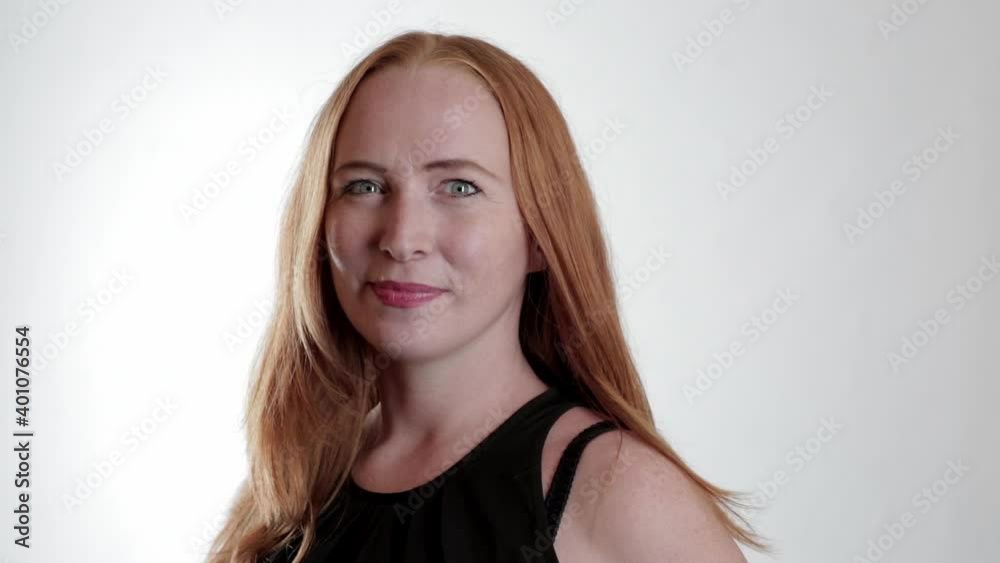 Portrait of smiling woman with red hair blowing in wind Portrait of smiling woman with red hair blowing in wind