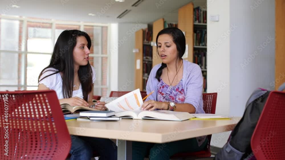 Hispanic women studying in university library