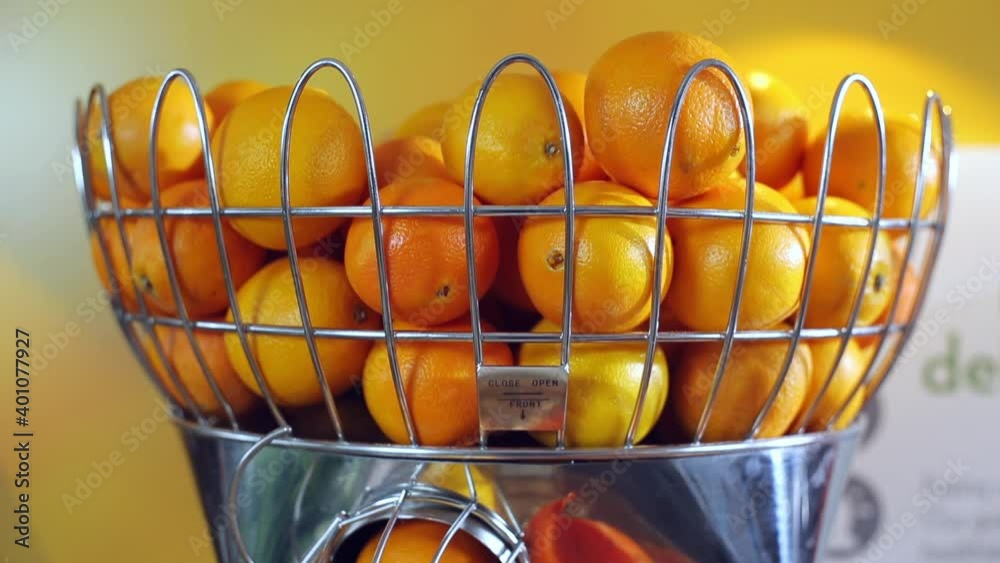 Close up of oranges processing in juice machine Close up of oranges processing in juice machine