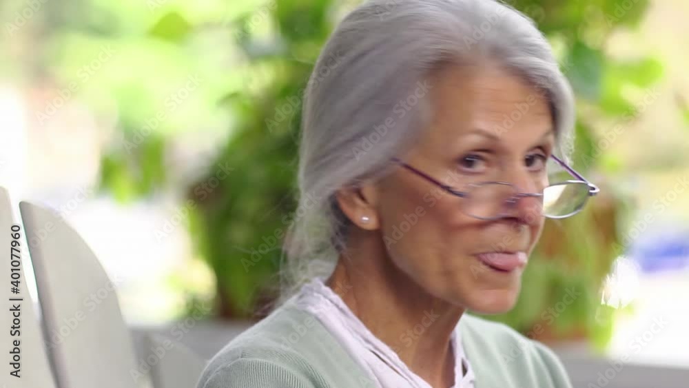 Close up of distracted senior woman smiling then looking away Close up of distracted senior woman smiling then looking away