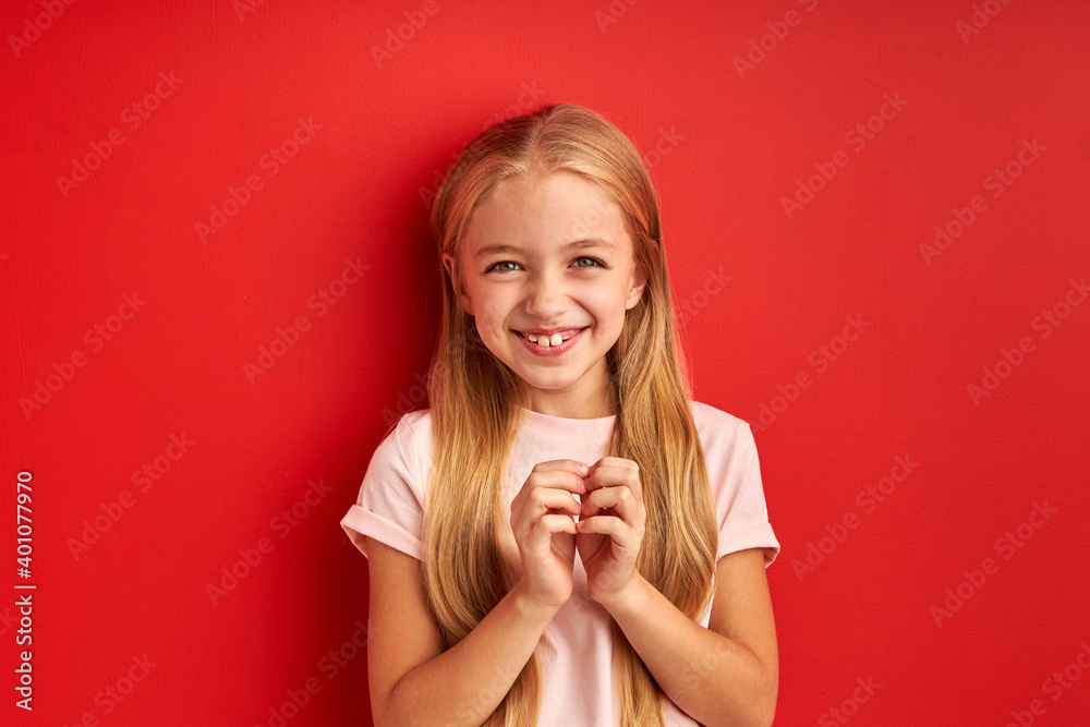 joyful little girl within temptation of birthday gift, stand waiting, looking at camera smiling joyful little girl within temptation of birthday gift, stand waiting, looking at camera smiling