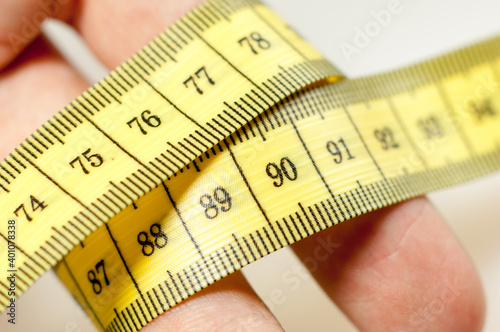 Tape measure wrapped around hands