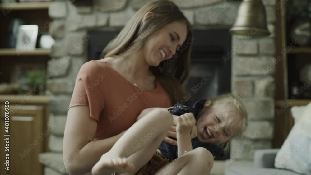 Mother holding and tickling playful daughter / Cedar Hills, Utah, United States Mother holding and tickling playful daughter / Cedar Hills, Utah, United States