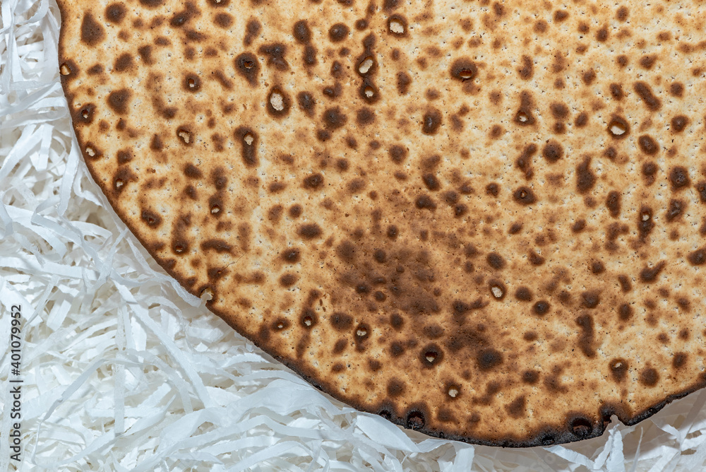 Matzo texture, a top view of a piece of traditional wheat dry bread served on Hebrew Passover Matzo texture, a top view of a piece of traditional wheat dry bread served on Hebrew Passover