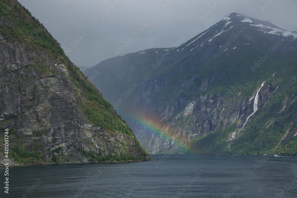 Beautiful rainbow over Geirangerfjord, located near the Geiranger village, Norway.
