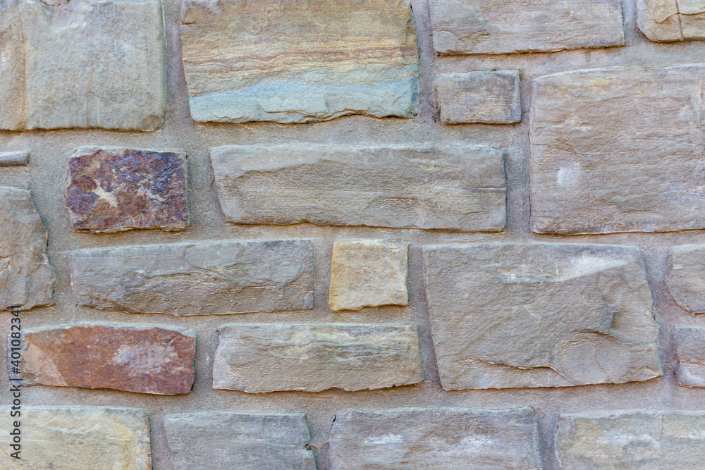 Fototapeta premium bright mediterranean stone wall with copy space, background.