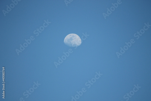 White waning moon in a blue sky