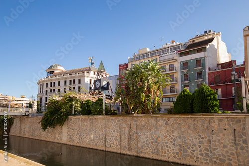 View of the Spanish city of Orihuela on the banks of the Segura River with colorful houses