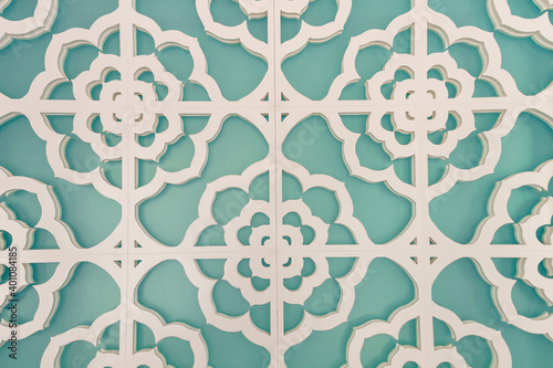 Aqua wall with a white abstract floral patterned overlay