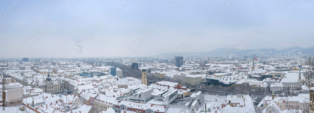 Cityscape of Graz with the Rathaus (town hall) and historic buildings rooftops with snow, in Graz, Styria region, Austria, in winter