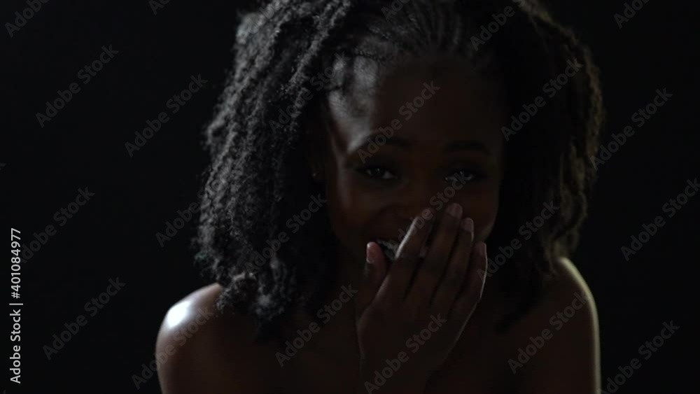Contorted Laugh African woman smiles and laughs for a long time and closes her mouth ...