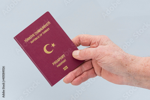 Turkish citizen public passport on the hand.