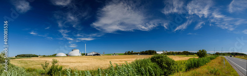 Panorama view of countryside in North Jutland with biogas plant, Denmark. Cornfield with agricultural factory in the background in the countryside. photo