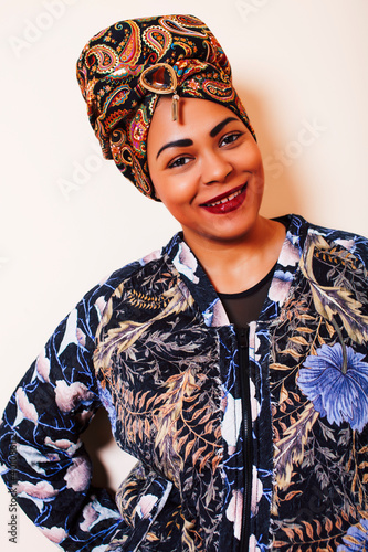 beauty bright african woman with creative make up, shawl on head like cubian closeup smiling photo