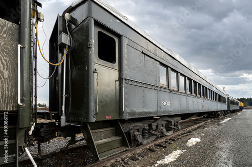 An empty abandoned train on the tracks in the city of Newport, Washington, USA, under cloudy skies during winter.