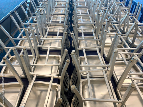 Stacked up metal chairs in rows