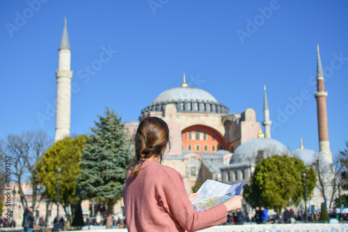 Photography Young tourist woman with map in front of  Hagia Sophia, Istanbul, Turkey