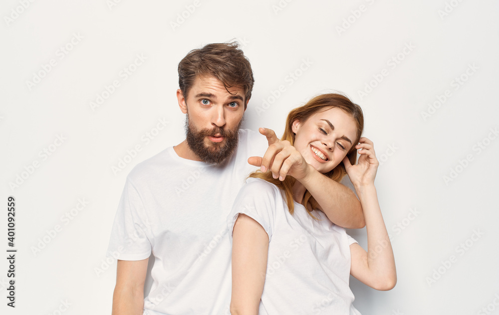 Man and woman stand next to t-shirts family casual wear lifestyle Man and woman stand next to t-shirts family casual wear lifestyle