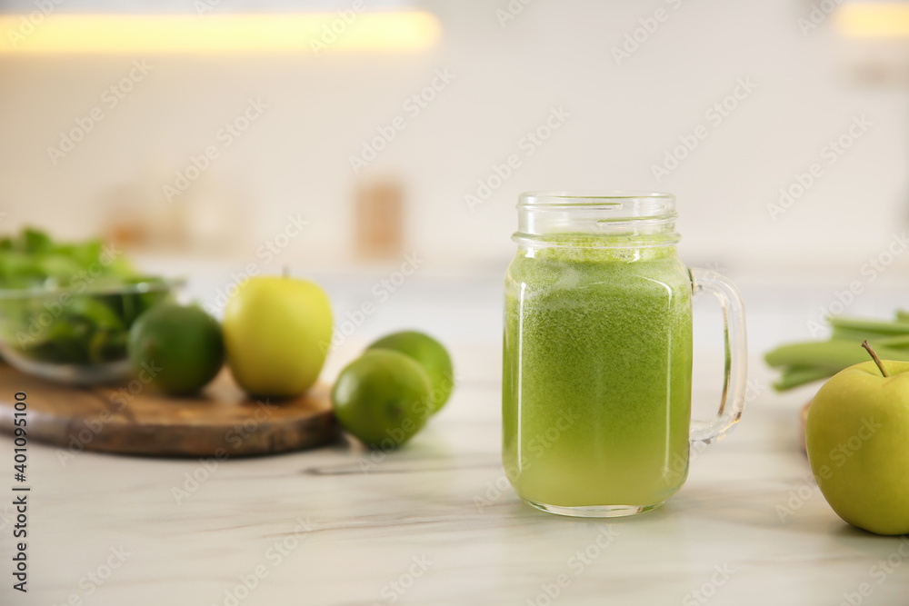 Tasty fresh juice in mason jar on table indoors. Space for text Tasty fresh juice in mason jar on table indoors. Space for text