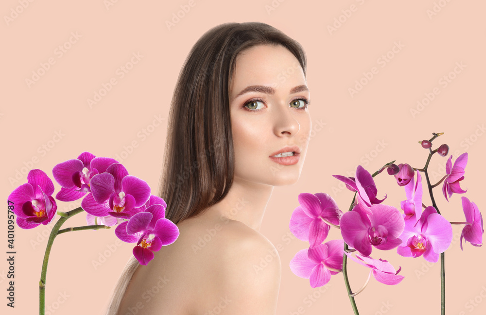 Beautiful young woman and orchid flowers on light background. Spa portrait Beautiful young woman and orchid flowers on light background. Spa portrait