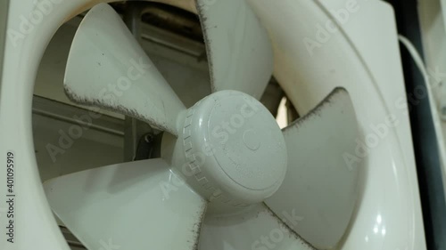 Dirty exhaust fan on the wall.