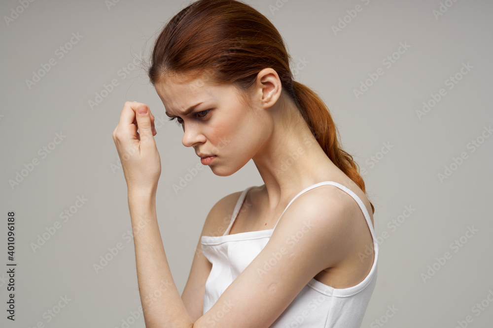 red-haired woman touching face with hands on gray background cropped view red-haired woman touching face with hands on gray background cropped view