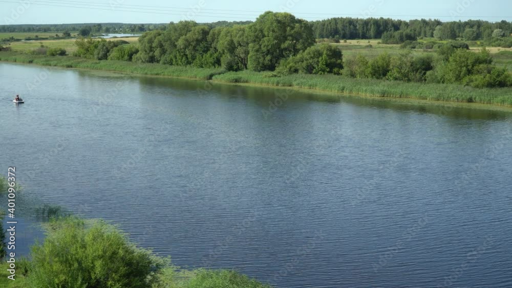High angle view of the riverbed from above in summer. Holidaymakers on a water bike move up the stream. Picturesque landscape in the countryside with a river stream on a sunny day from the top. High angle view of the riverbed from above in summer. Holidaymakers on a water bike move up the stream. Picturesque landscape in the countryside with a river stream on a sunny day from the top.