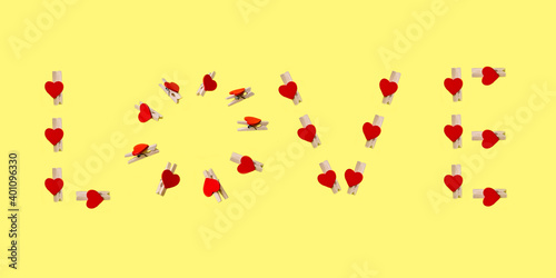 Love letters from clothespins on yellow background 