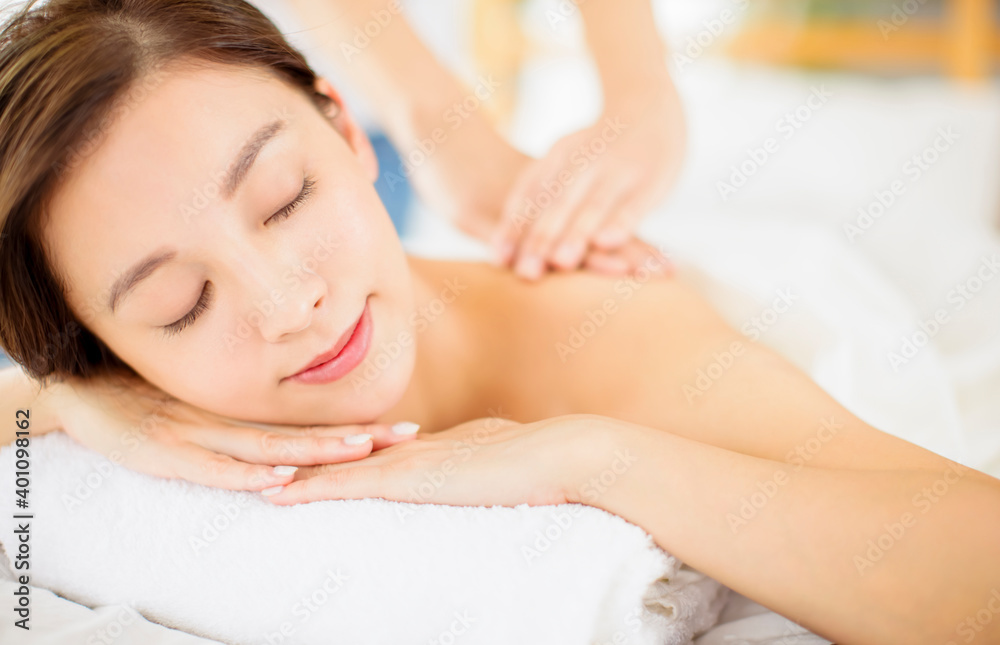 relaxed Young woman enjoy massage in spa salon