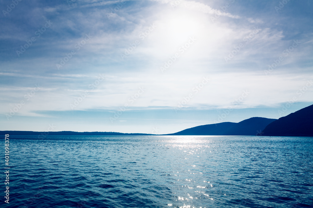 Sun over the blue sea and mountains . Blue tide and islands Sun over the blue sea and mountains . Blue tide and islands