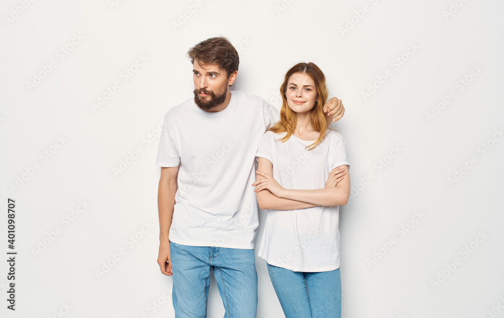 Man and woman stand next to t-shirts family casual wear lifestyle Man and woman stand next to t-shirts family casual wear lifestyle