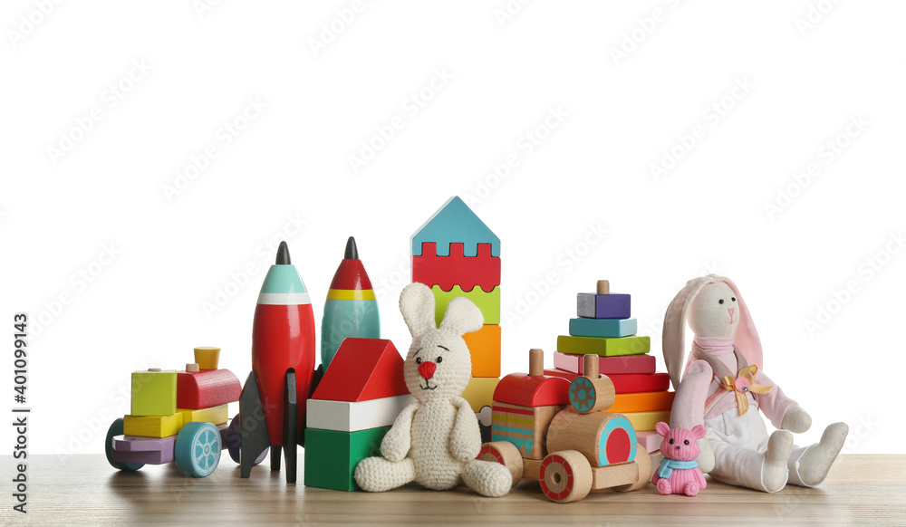Obraz premium Set of different toys on wooden table against white background