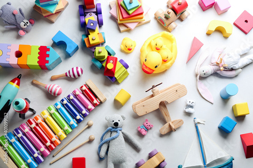 Different toys on light background, flat lay photo