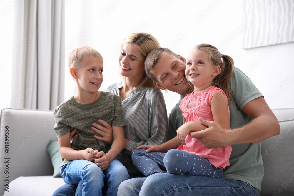 Happy family with children on sofa at home Happy family with children on sofa at home