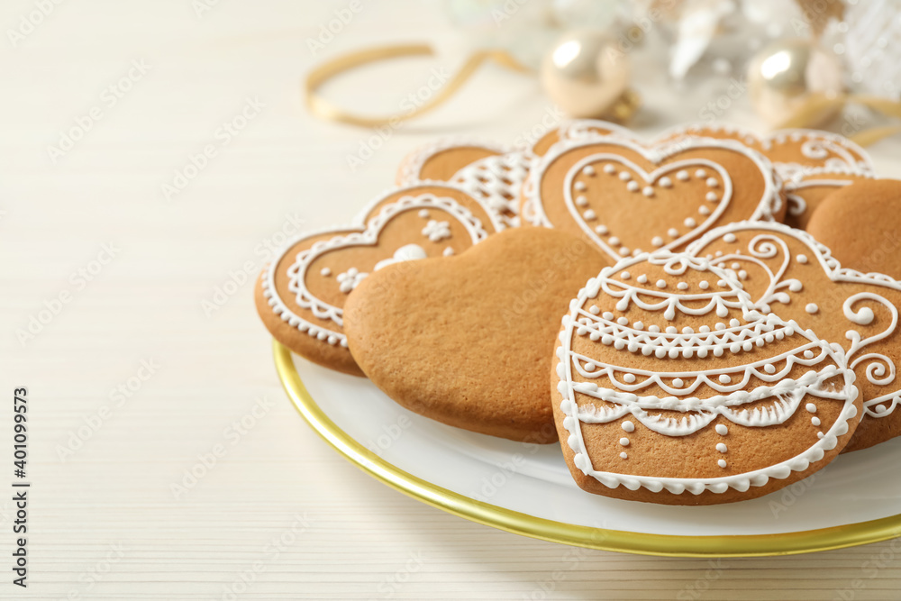 Tasty heart shaped gingerbread cookies on white wooden table, closeup Tasty heart shaped gingerbread cookies on white wooden table, closeup