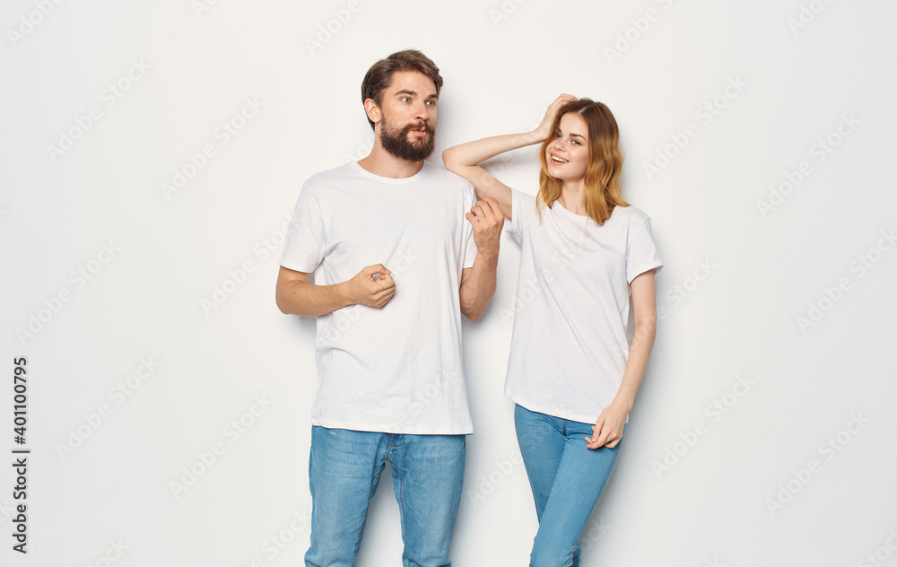 Couple in love man and woman light background fun emotions the same clothes Couple in love man and woman light background fun emotions the same clothes