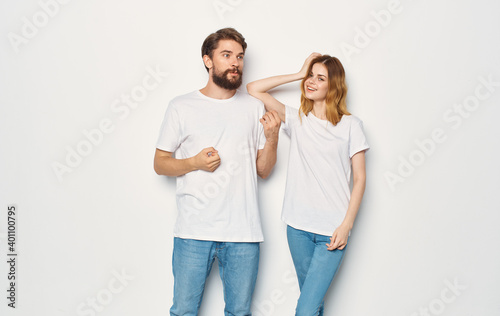 Couple in love man and woman light background fun emotions the same clothes