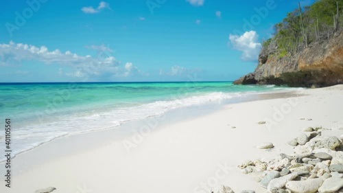 Dolly shot of a remote white sandy beach in Aruba photo