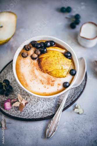 Semolina porridge with pear and aronia berries photo