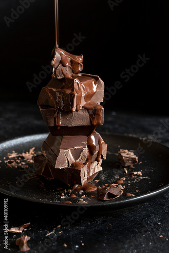 Stack of chocolate cubes on black background photo