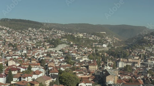 Wallpaper Mural 
Aerial view Bosnia and Herzegovina. The drone flies over the houses with red roofs that stand in a landscape in the mountains and the sky, mountain ranges and peaks are visible. Torontodigital.ca