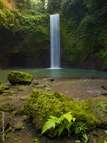 Waterfall landscape. Beautiful hidden waterfall in tropical rainforest. Nature background. Slow shutter speed  motion photography. Tibumana waterfall  Bali  Indonesia