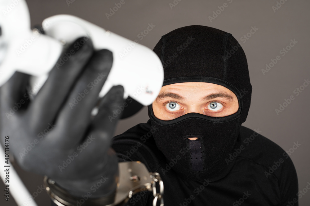 Thief turning off surveillance camera Thief turning off surveillance camera