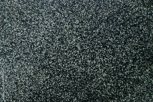 Air bubbles in the water on a dark background.