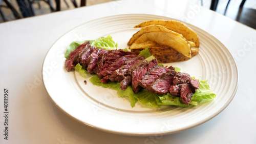 Medium rare steak on a plate. High end cuisine restaurant. Healthy source of protein.