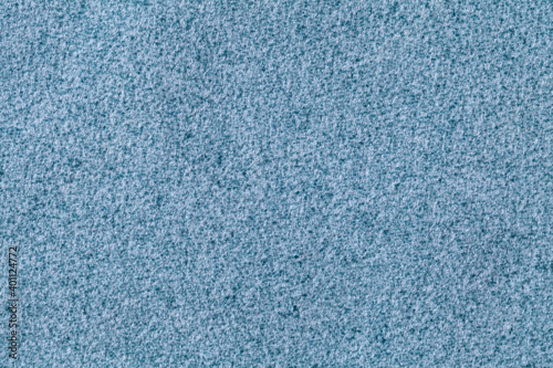 Blue fluffy background of soft, fleecy cloth. Texture of denim wool textile.